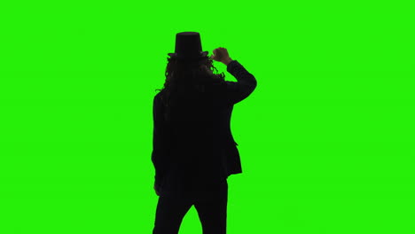 silhouette of a man in a suit and hat on green screen