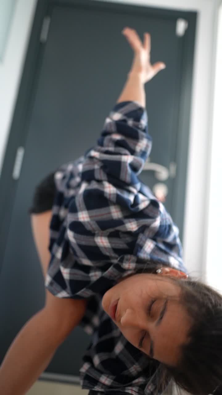 Woman Dancing in a Plaid Shirt