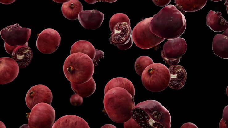 Falling pomegranate on a black background
