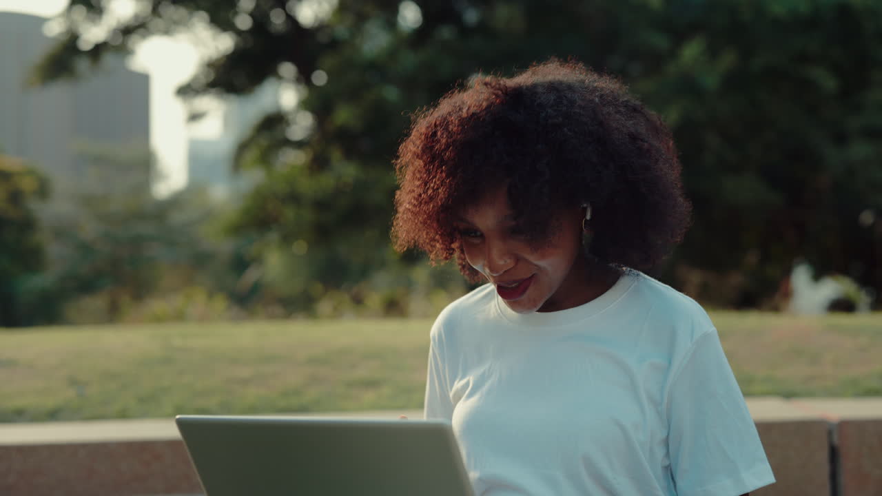 mujer usando una computadora portátil al aire libre