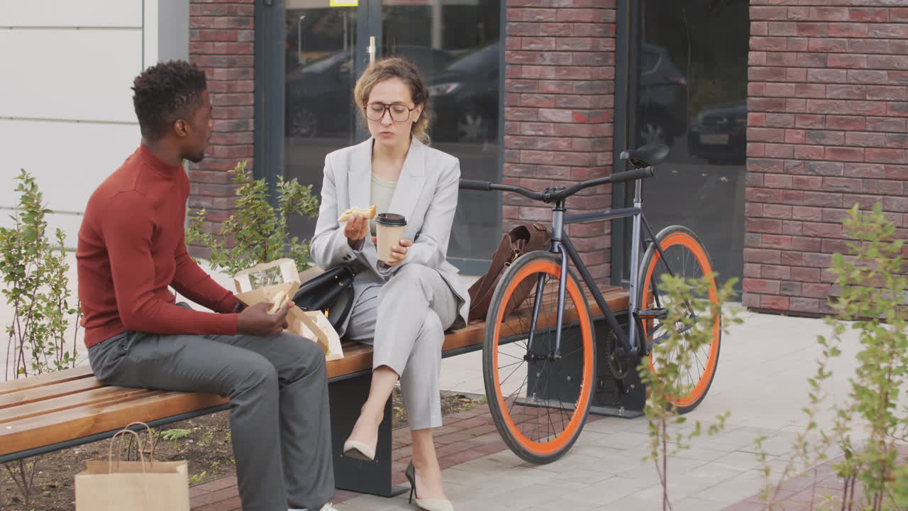 Interracial Colleagues Having Lunch Outdoors Together