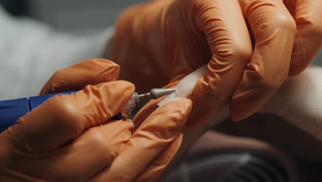 professional nail technician performing manicure