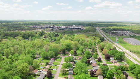 aerial drone footage of suburban neighborhood and solar panel plant in the fields