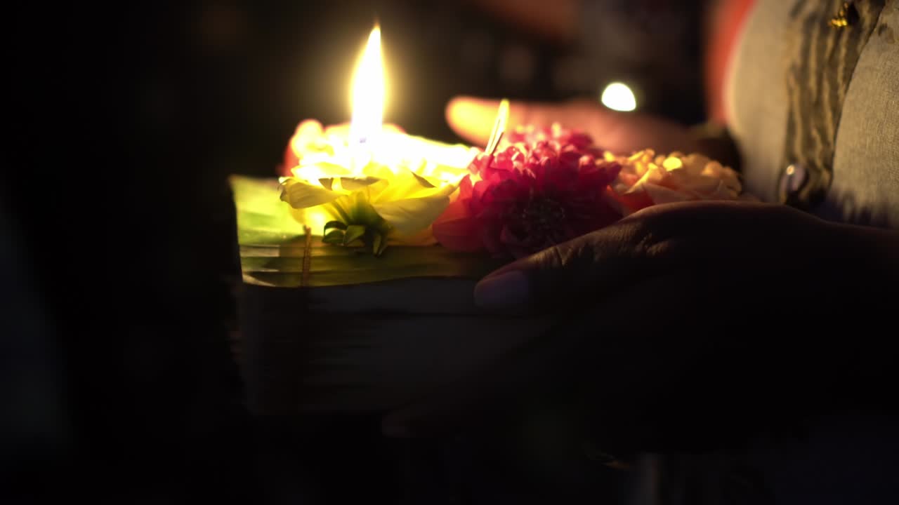 Indian girl hand hold the lamp of candle with flower