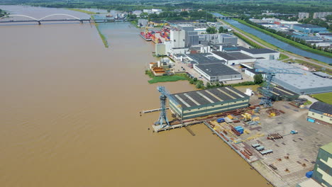 antena de una hermosa zona industrial con grandes grúas cerca del río