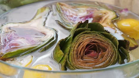 close-up of artichokes soaking in lemon water