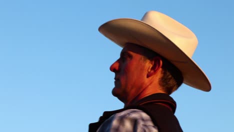 cowboy mounts his horse ready to begin his ride in nature