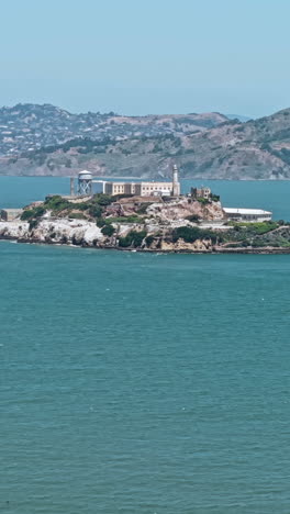 vertical drone shot of alcatraz island and former prison buildings. sam francisco bay, california usa