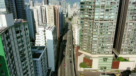 Aerial-shot-of-Downtown-Hong-Kong-mega-residential-skyscrapers-and-traffic,-on-a-beautiful-day