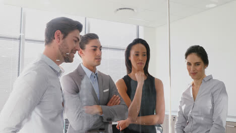 Group-of-executives-discussing-over-invisible-screen-4k