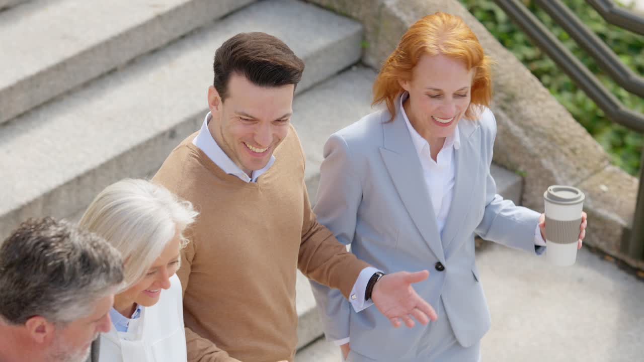 Business professionals walking and conversing on outdoor stairs