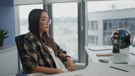 disappointed freelancer sitting office with city view. woman looking solution