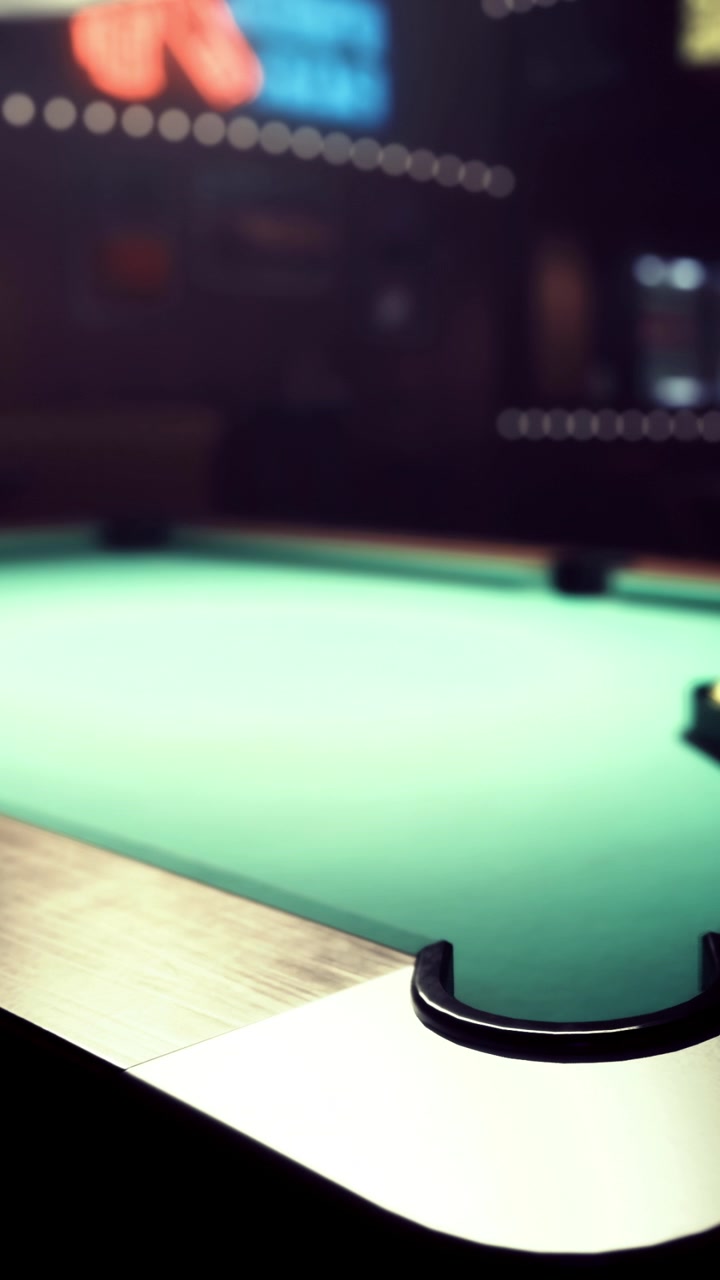 Pool table and balls in a bar setting during evening hours