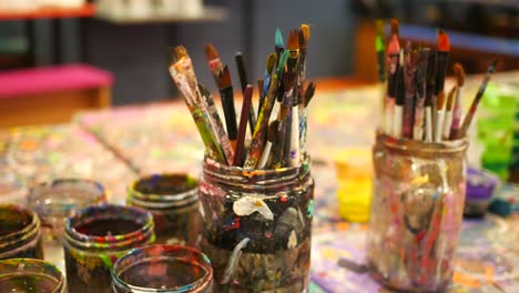 paints and paint brushes in an artists studio