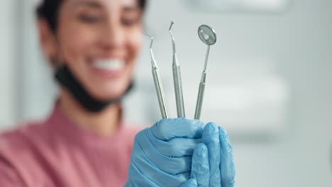 dentist holding dental tools