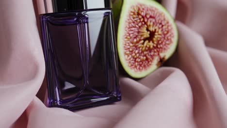 fig perfume on pink fabric
