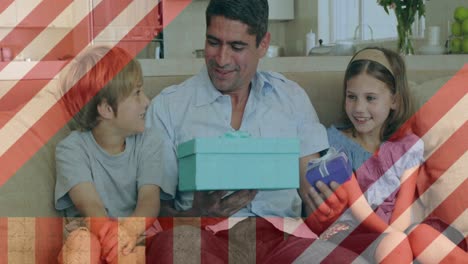 Animation-of-american-flag-over-caucasian-father-and-children-with-gifts
