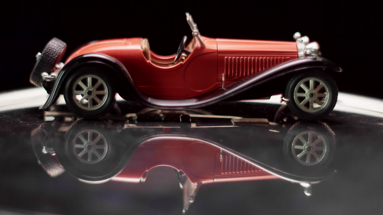 Red Vintage Model Car with Reflection
