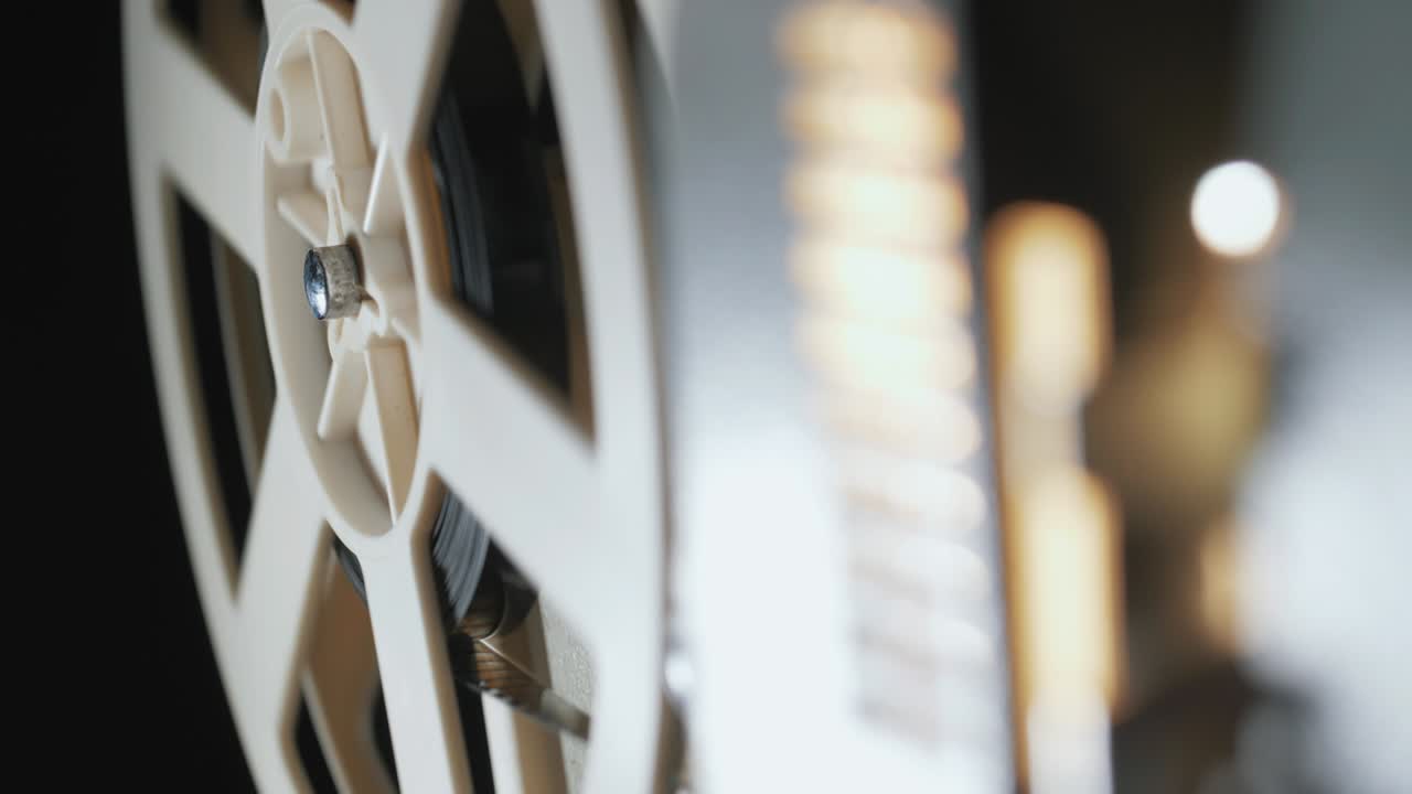 film projector on a black background with dramatic lighting and selective focus. Retro film production accessories still life. Concept of film-making. Smoke effect on background