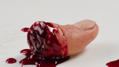 a rubber fake finger with blood close-up. make-up equipment props for films and shooting. bloody fake fingers for halloween and parties