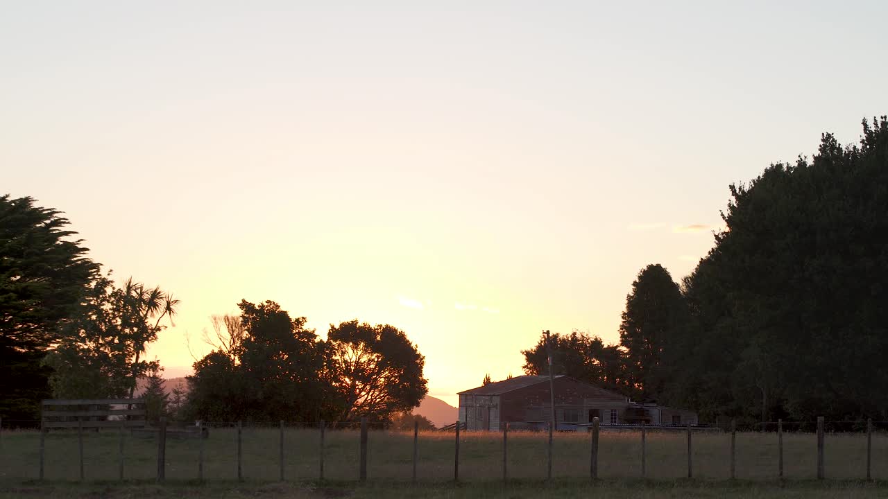 The Stunning Scenery Of An Unique House Surrounded By Green Trees During Golden Hours in New Zealand - Wide Shot