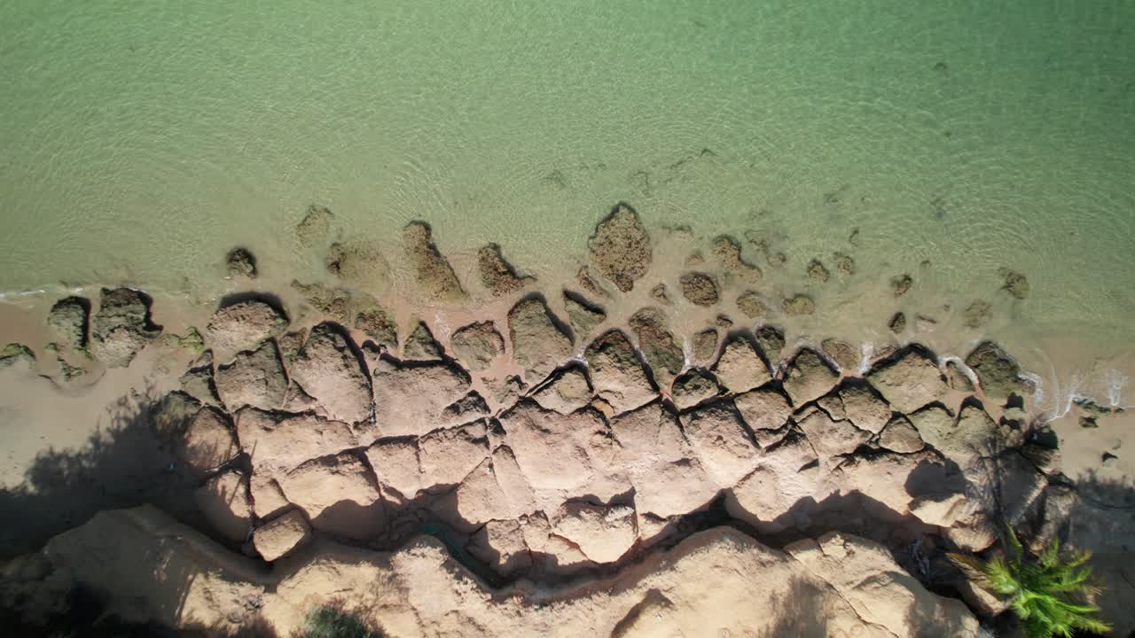 Zenith aerial view Araya beach rocky breakwater turquoise sea