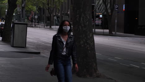 woman walking down bourke st wearing mask during covid19 melbourne