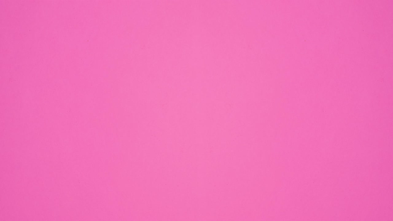 Biscuit cookies move on left and right side of vibrant pink background with copy space. Stop motion flat lay