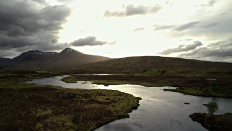 Golden-Sun-Bursts-Through-Dark-Clouds-In-Rannoch-Moor,-Scotland-Highlands