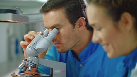 Man-and-woman-scientists-talking.-Close-up-of-scientists-working-together