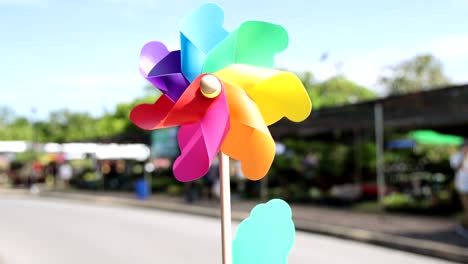 a vibrant pinwheel spins rapidly in a sunny setting.