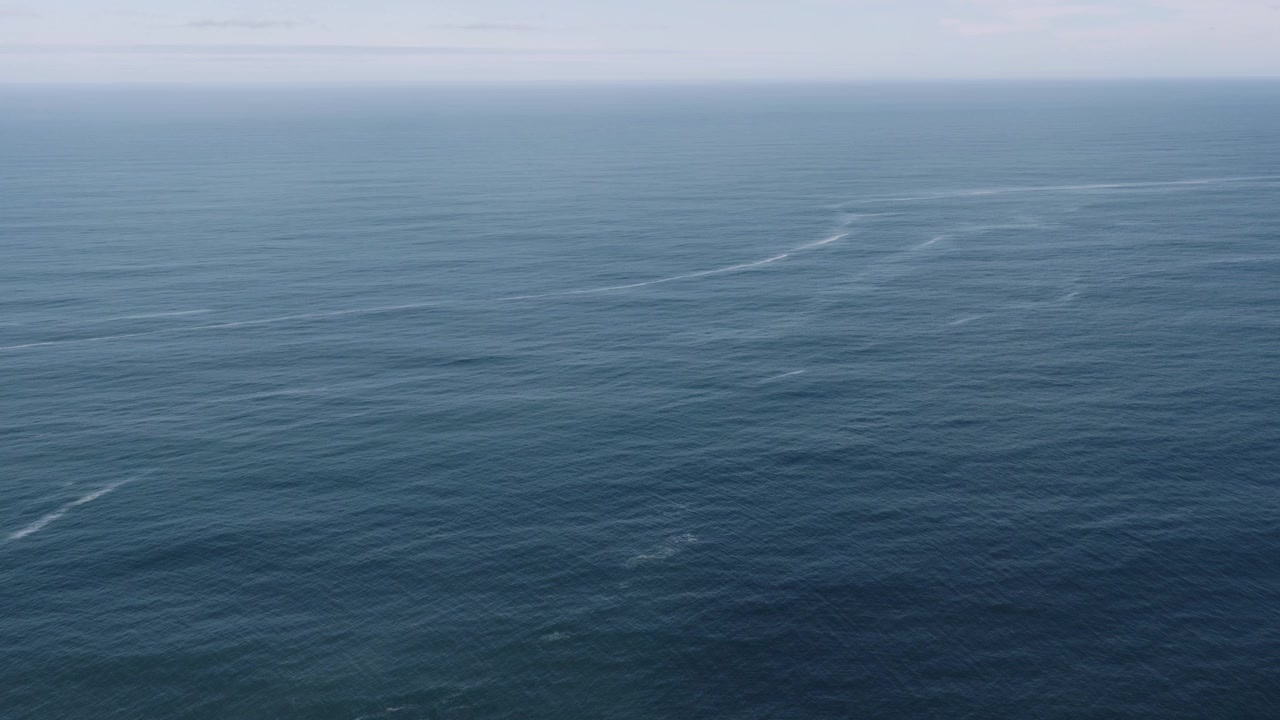 Aerial Wide Open Ocean Calm Tide, Tracking Forward Tilt Down