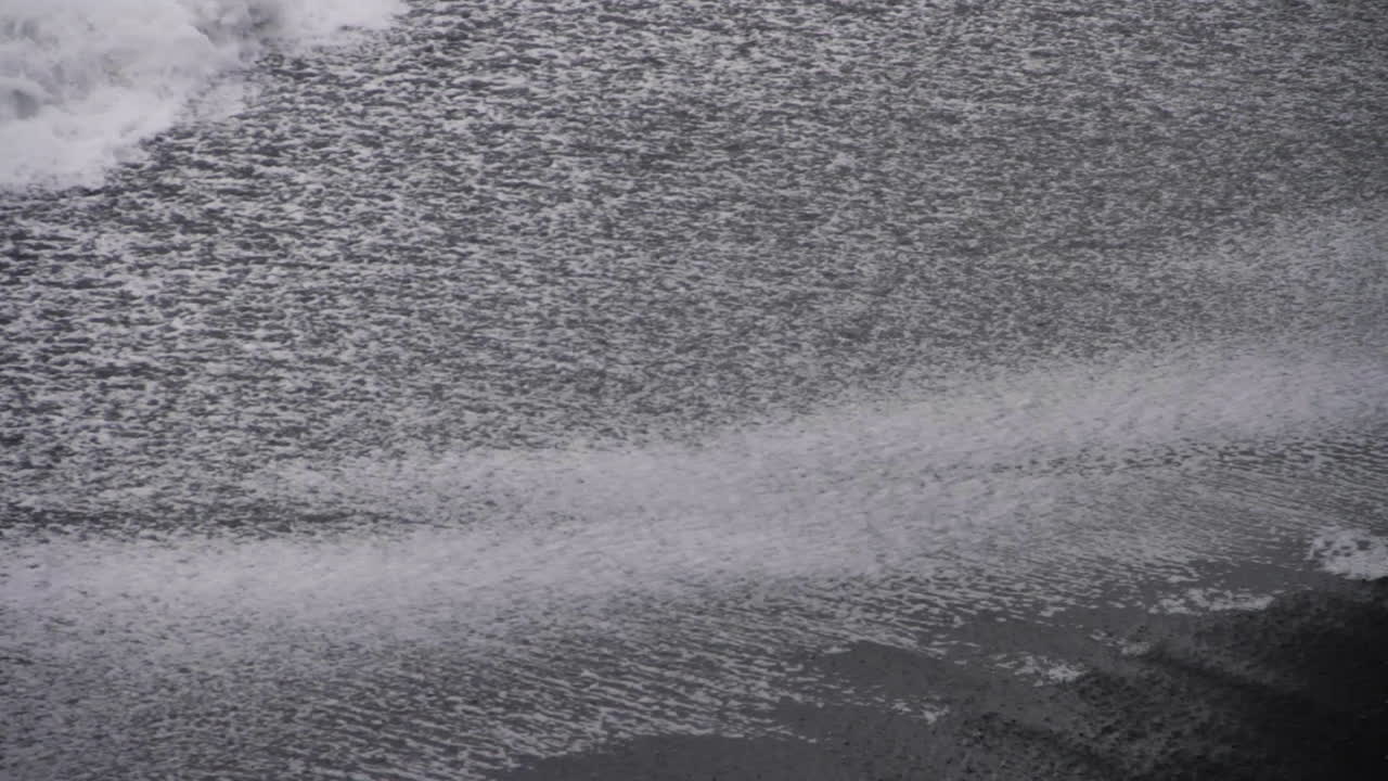 Waves Splash against Shore on Icelandic Black Sand Beach