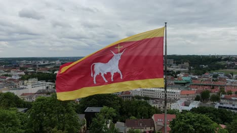 kaunas city flag waving above downtown rooftops, close up view