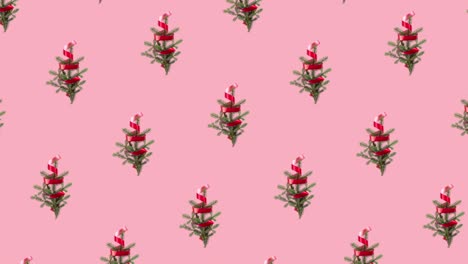 animación de patrón sin costuras con muchas ramas de abeto y cinta rizada roja. movimiento diagonal en diferentes direcciones. árbol de navidad y concepto de año nuevo con espacio de copia en fondo pastel rosa