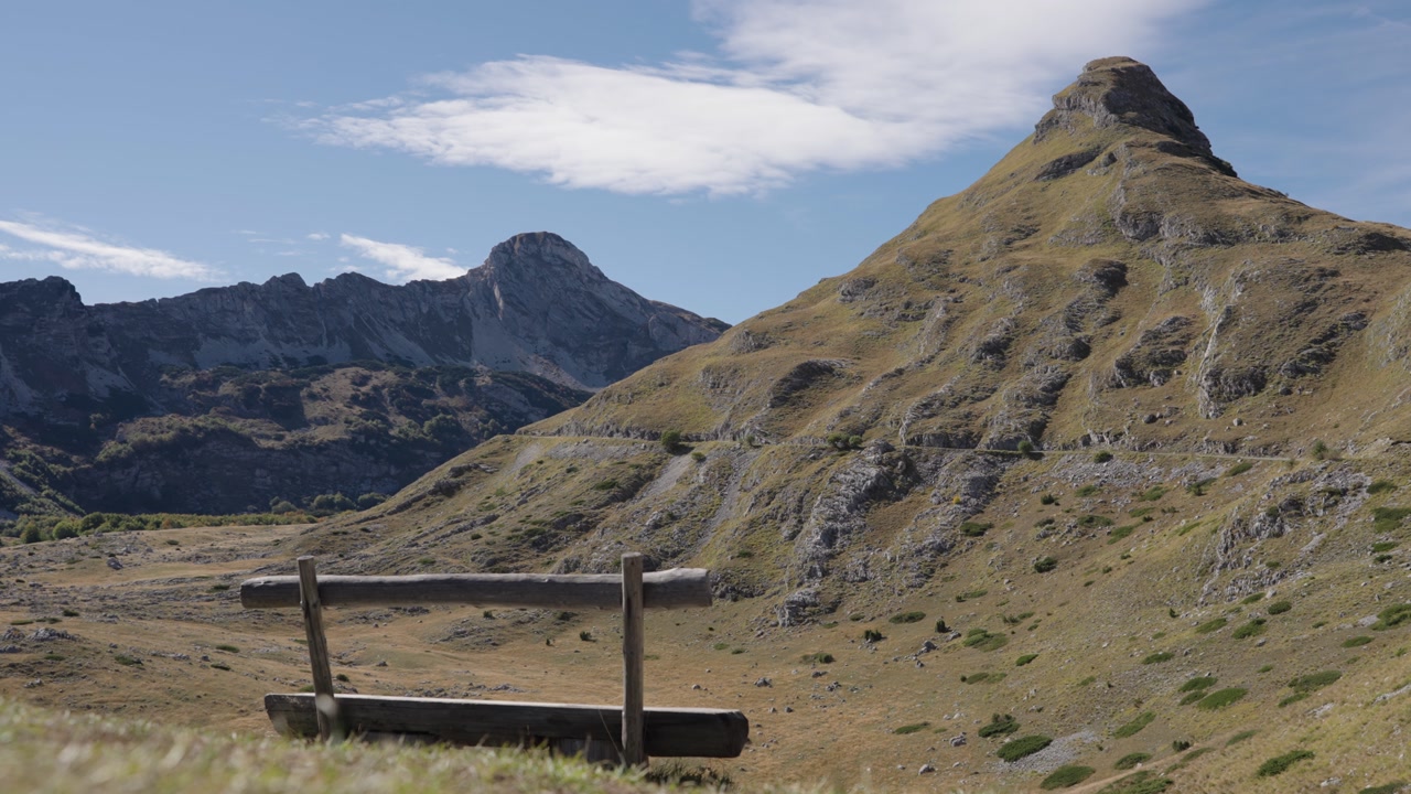 Rocky landscape with a barrier, mountains and a meadow in the Durmitor massif during the day in Montenegro, static shot