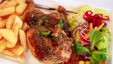 delicious fried chicken wings and french fries served with salad, close up view