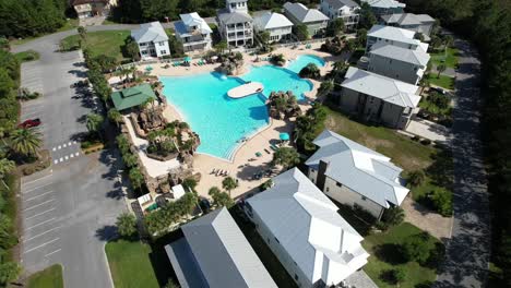 houses surrounding a pool - drone shot