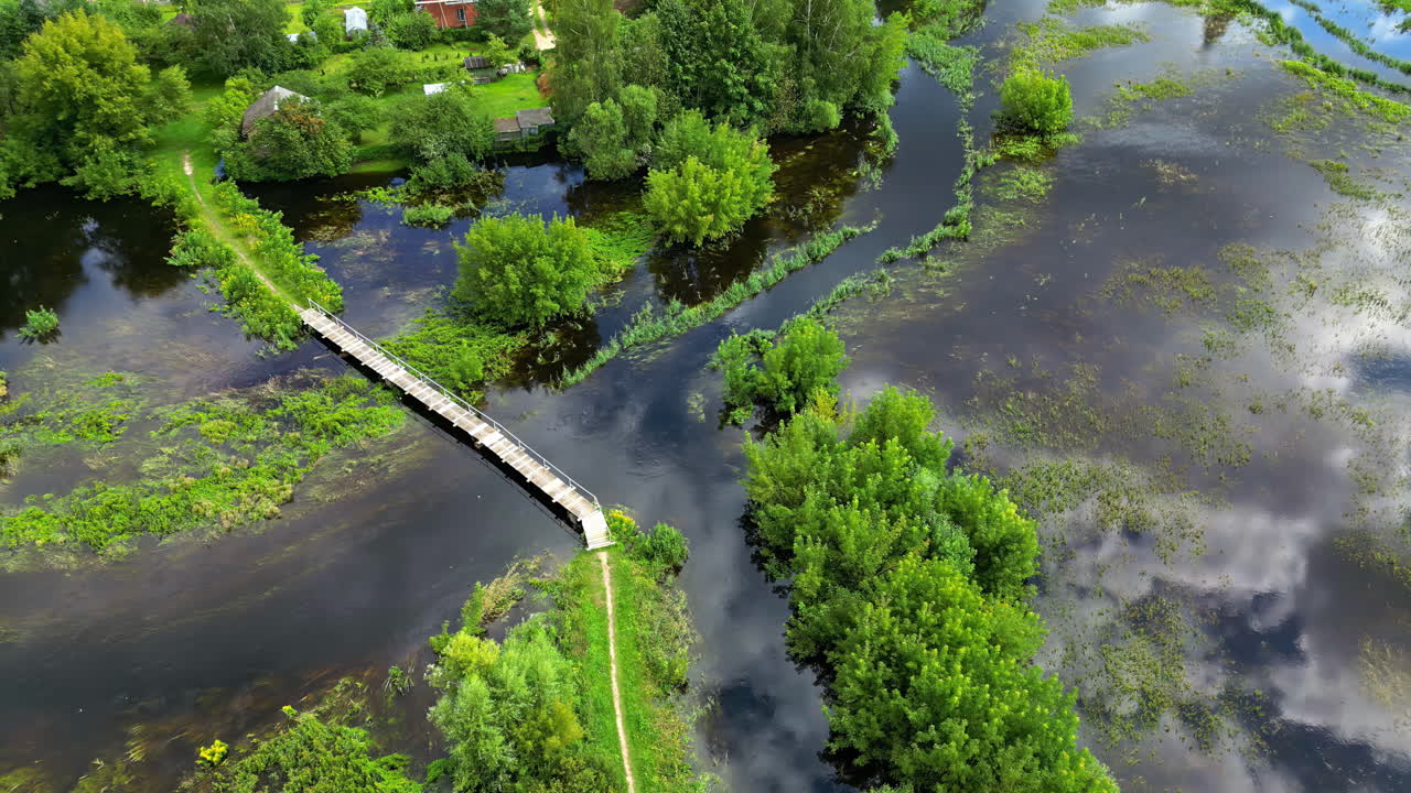 Aerial View of Flooded Village with Footbridge