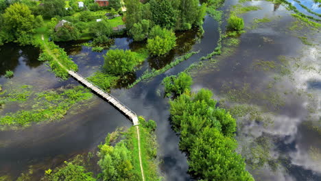 aerial view of flooded village with footbridge
