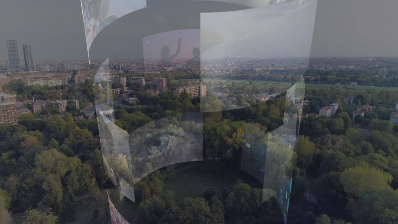 Digital screens displaying animation over cityscape and park in aerial view