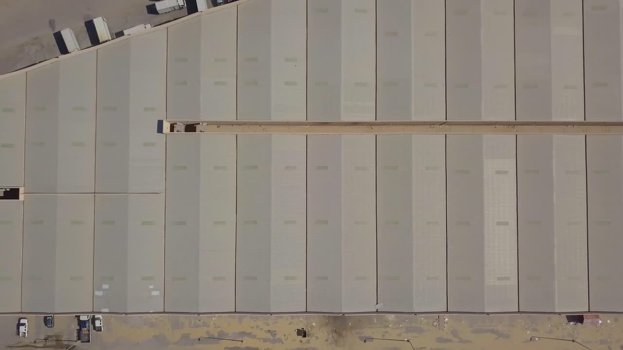 수직 조감도는 트럭과 함께 사막에 나란히 있는 많은 저장 시설 창고를 축소합니다.