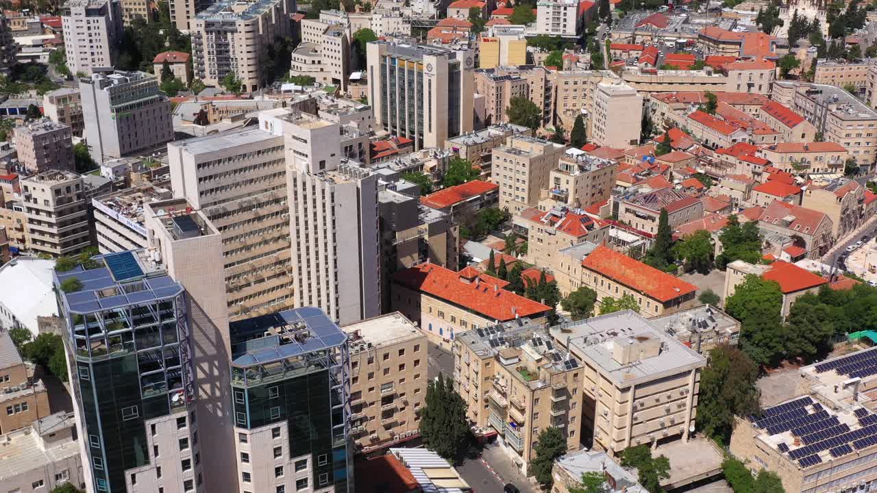 Aerial view of a sprawling city with a mix of modern high-rise buildings and traditional structures
