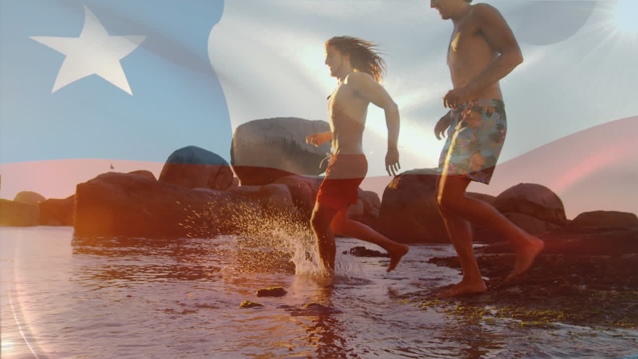 Animation of waving chile flag against group of diverse friends running and having fun at the beach