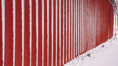 Snow-on-Red-Wall-Causing-White-Line-Patterns,-Aomori-Japan