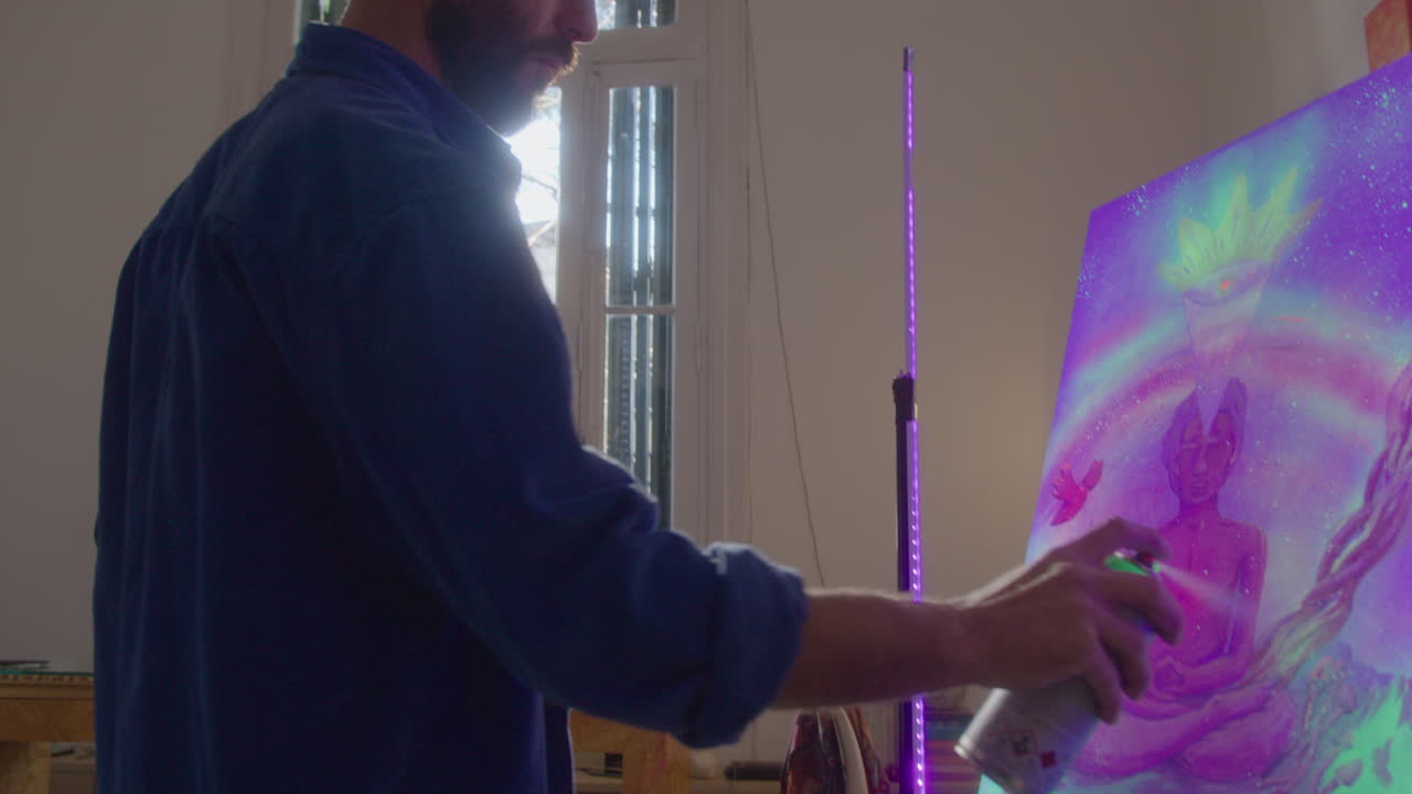 Creative Artist Using UV Spray Paint at Work in Studio