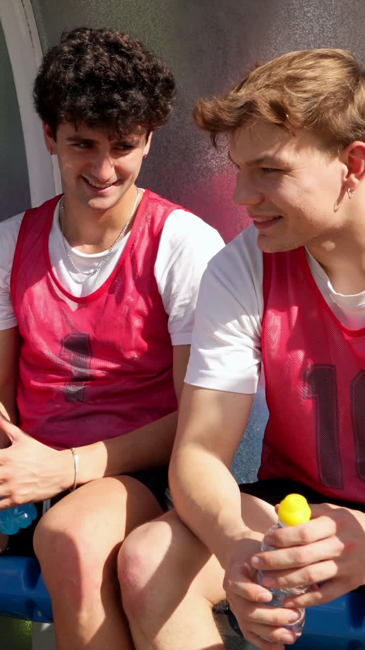 Soccer Players Resting on Bench