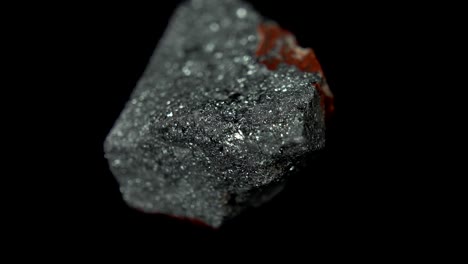 seamlessly rotating a metallic-gray mineral (hematite) in front of black background