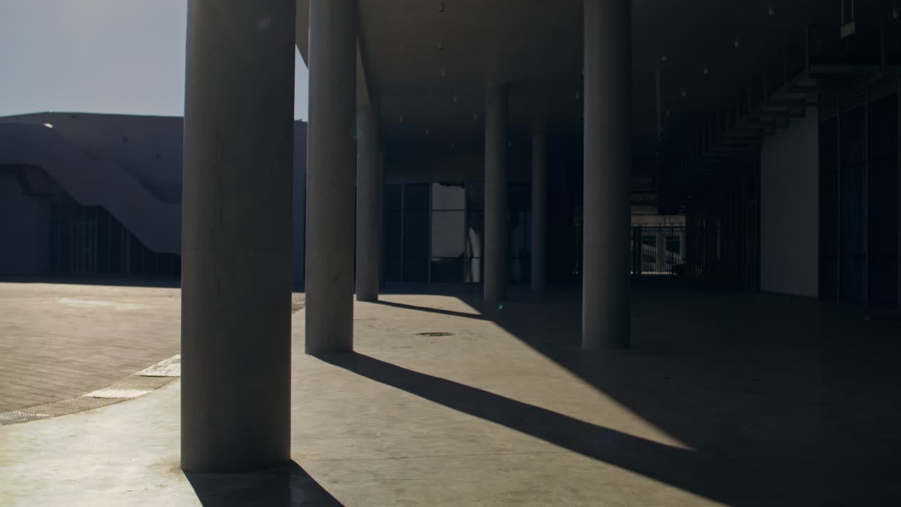 Woman Running Through Building Columns