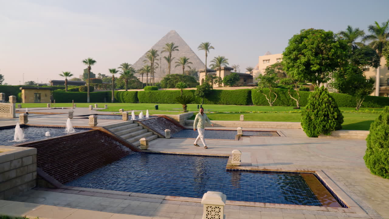 Man In Hotel Complex With View Of Pyramids In Giza, Egypt - Drone Shot